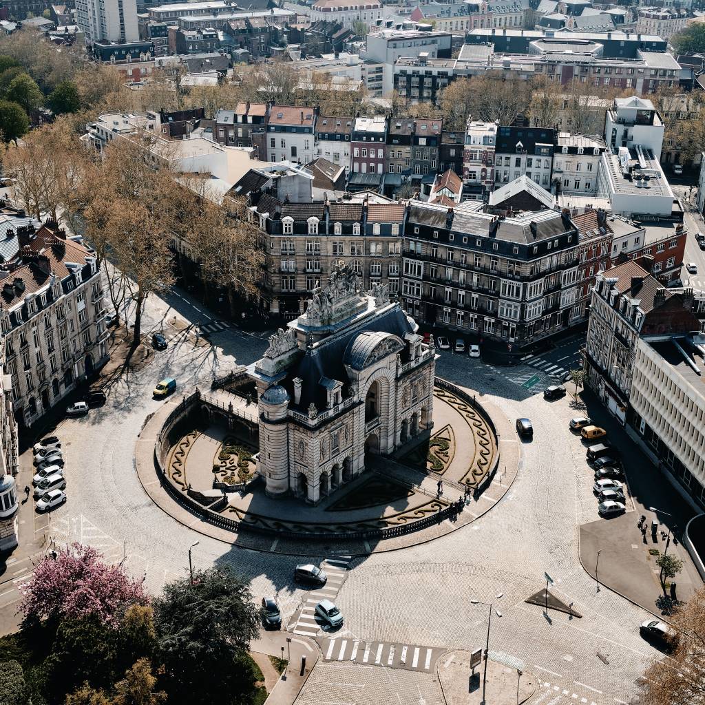 An aerial shot of a cityscape with a lot of cars and beautiful buildings in Lille, France